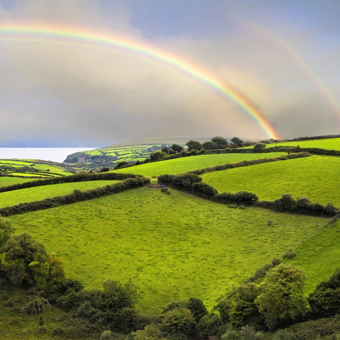 Double rainbow landscape in Dingle Peninsula scenery., taken on sunny and rainy day.